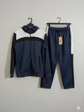 Navy and white tracksuit with a Nike tag on a gray background