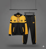 Yellow and black tracksuit with 'CAT' branding on a gray background