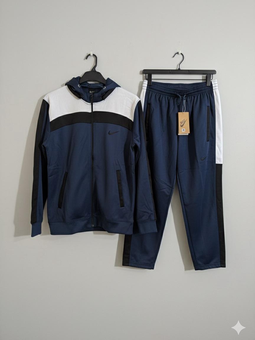 Navy and white tracksuit with a Nike tag on a gray background