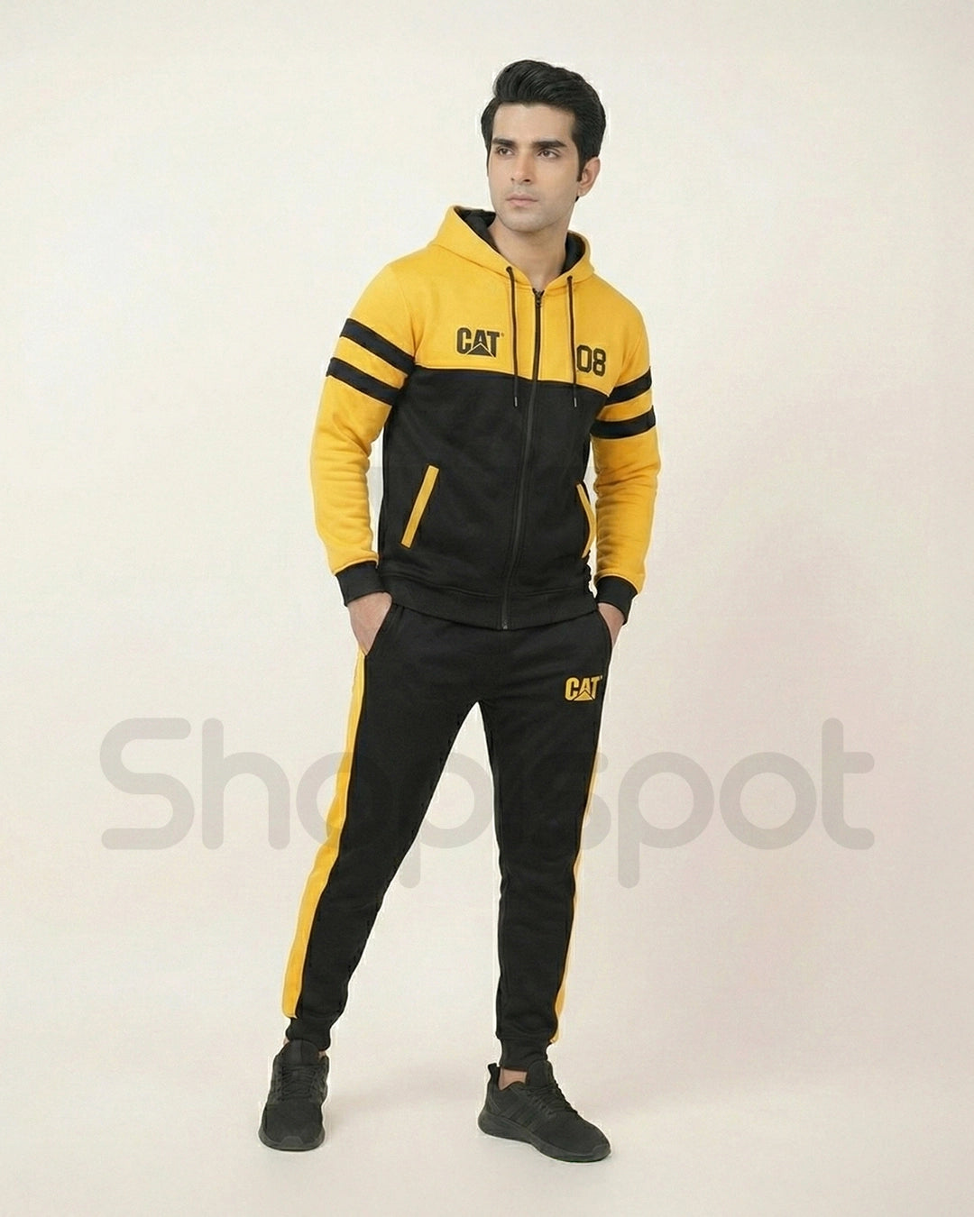 Yellow and black tracksuit with 'CAT' branding