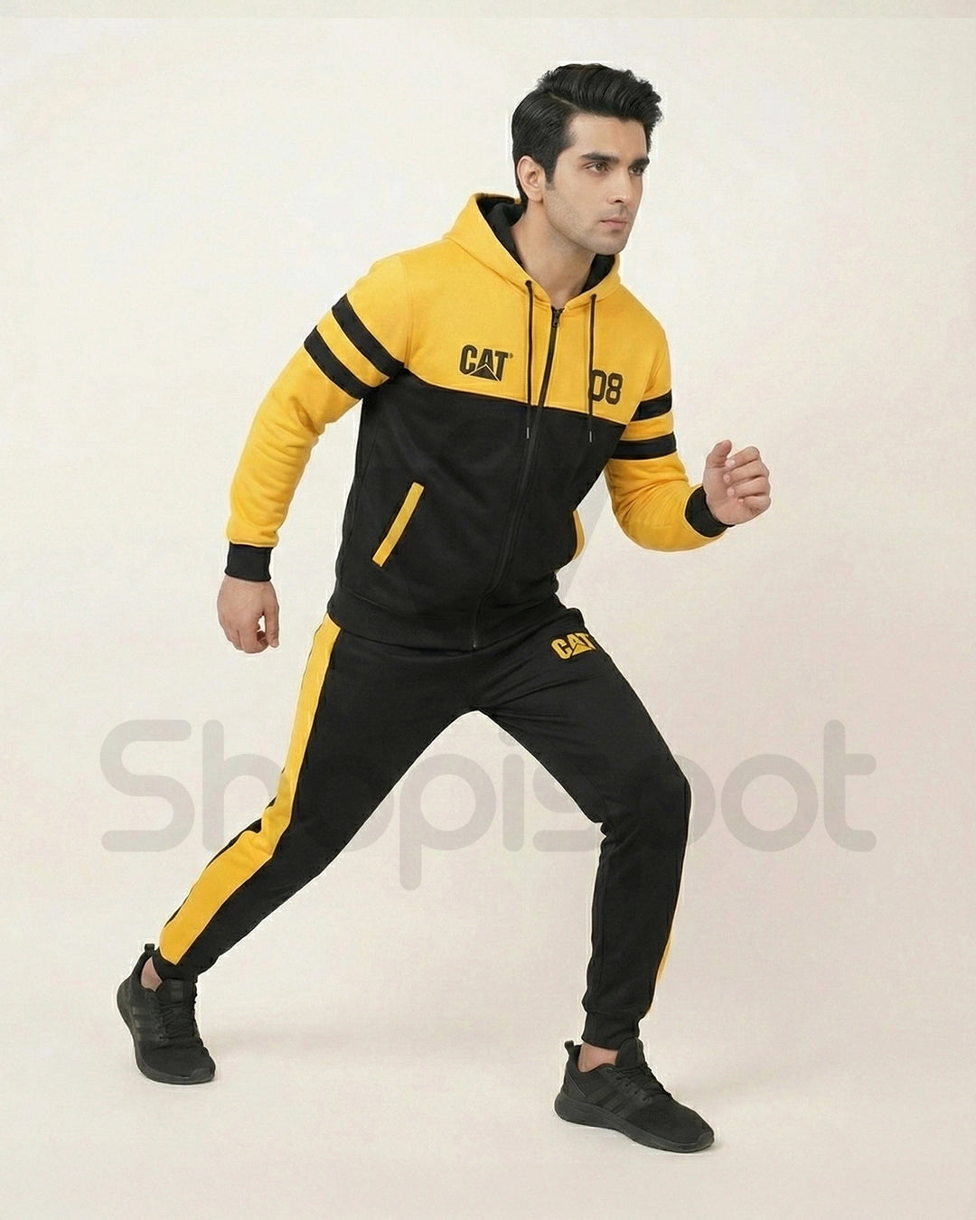 Yellow and black tracksuit with 'CAT' branding