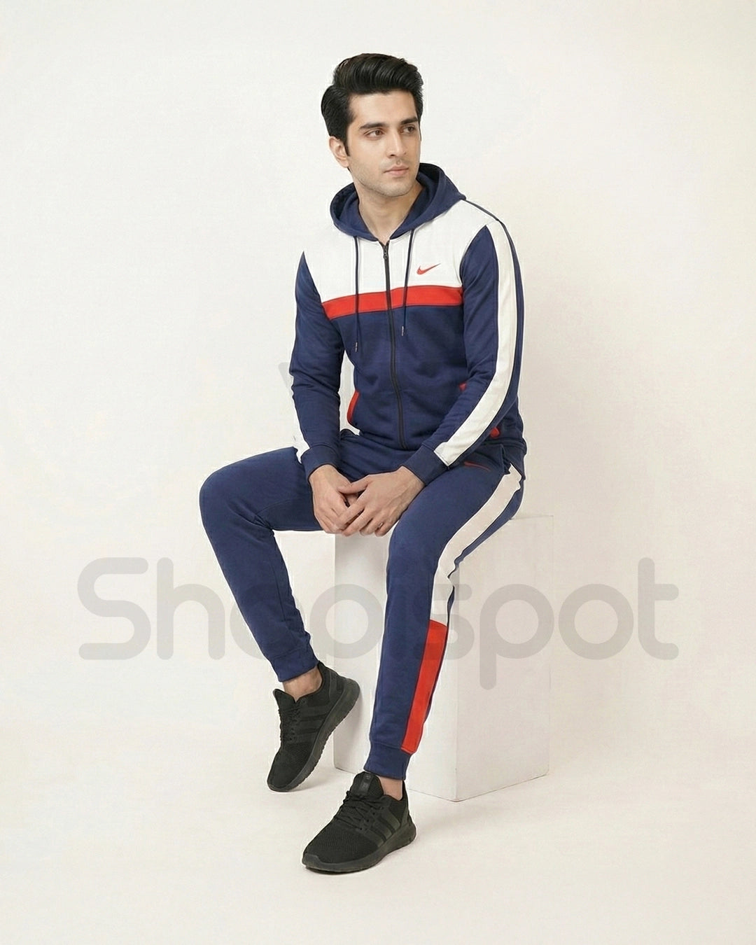 Navy tracksuit with red and white accents