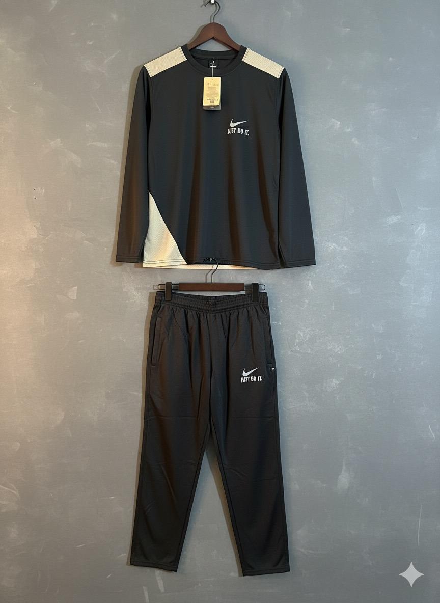 Black Nike tracksuit with white accents on a gray background