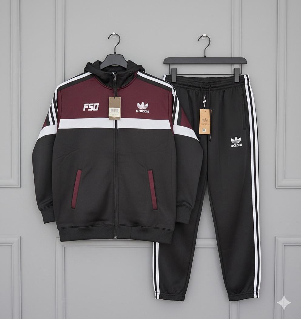 Black and maroon tracksuit with Adidas logo on a gray background