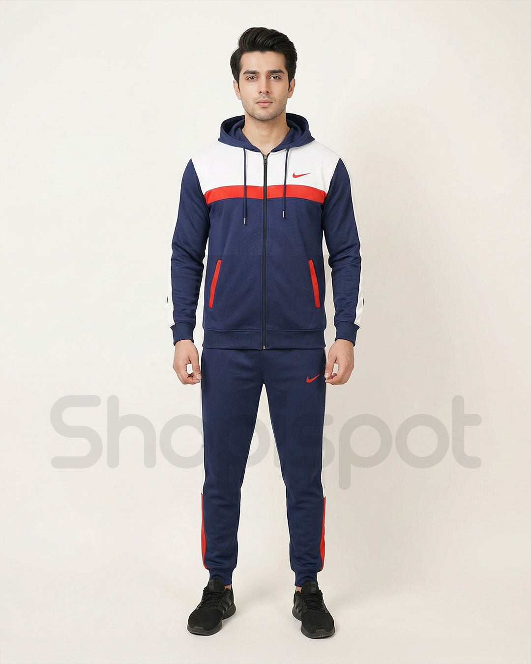 Navy tracksuit with red and white accents