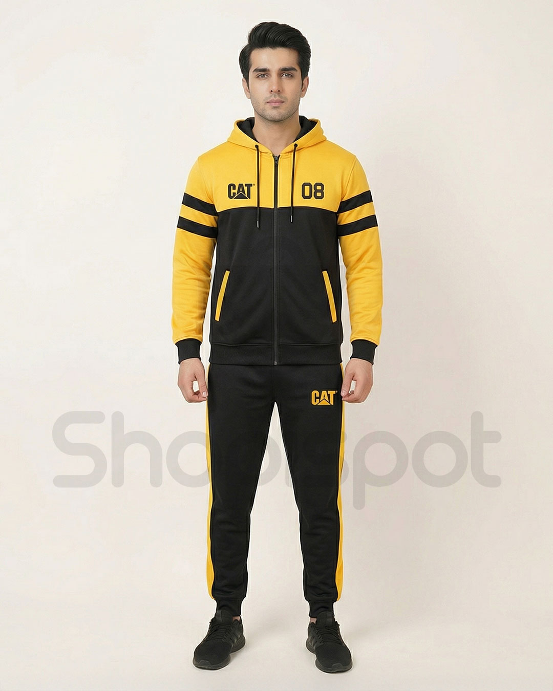 Yellow and black tracksuit with 'CAT' branding