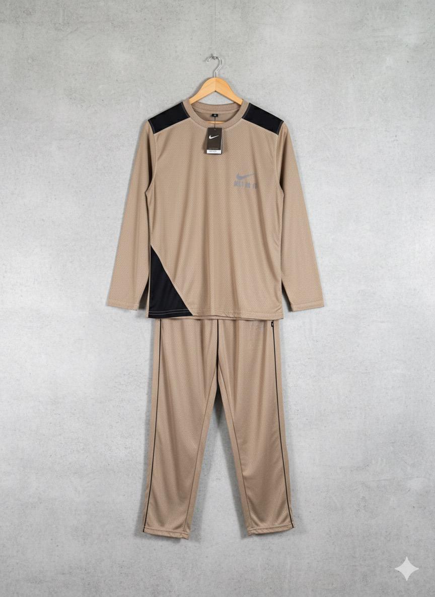 Beige tracksuit with black accents on a hanger against a gray background
