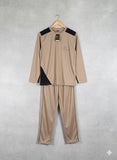 Beige tracksuit with black accents on a hanger against a gray background